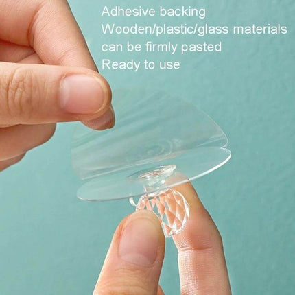 Invisible Cabinet Drawer Handle 2 Pack With Self Adhesive Suction Cups clear acrylic invisible knob being held for adhesive installation on smooth surfaces