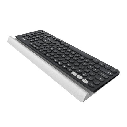 Logitech K780 Multi-Device Wireless Keyboard for Easy Typing shown angled on white stand with round keys and device cradle
