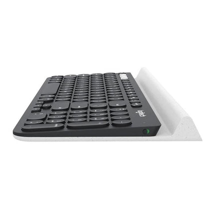 Logitech K780 Multi-Device Wireless Keyboard for Easy Typing shown side profile on white stand, compact round keys and device cradle