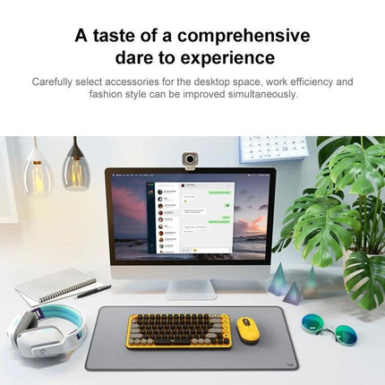 Logitech POP Keys Round Button Bluetooth Mechanical Keyboard on desktop with monitor, mouse, headphones and accessories