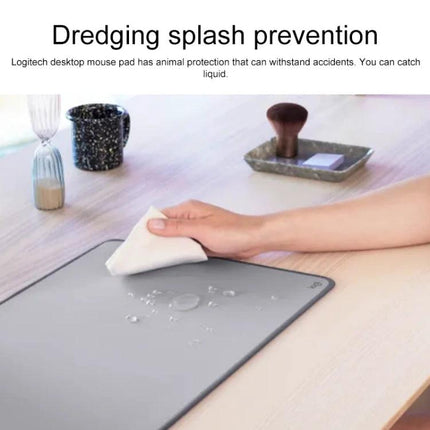 Logitech Soft Cloth Mouse Pad for Comfortable Daily Use - lavender desk pad with water droplets being wiped clean