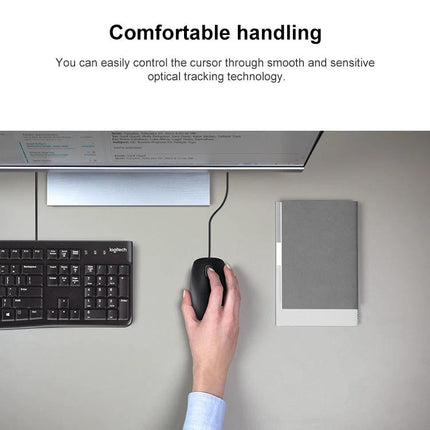 Logitech Quiet Wired USB Mouse for Everyday Office Tasks - top view of hand using quiet wired mouse at office desk with keyboard and notebook