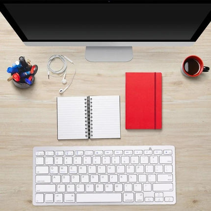 Wireless Bluetooth Keyboard for Computers and Tablets compact 78-key white keyboard on desk with monitor notebook and coffee