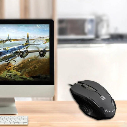 Chasing Leopard Wired Optical Gaming Mouse with 512GB Storage shown on desk next to gaming monitor in FPS setup