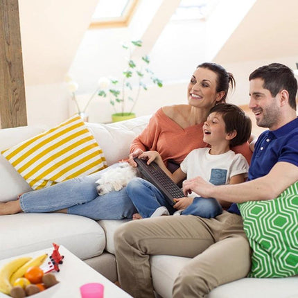 Logitech K400 Plus Wireless Keyboard for Living Room Navigation showing family on couch using built-in touchpad to browse TV