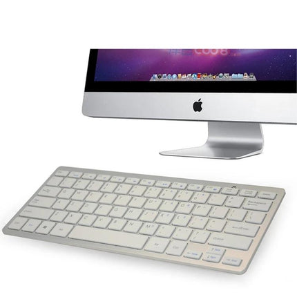 Wireless Keyboard and Optical Pen Mouse Set for Everyday Computing - slim low-profile keyboard beside desktop monitor