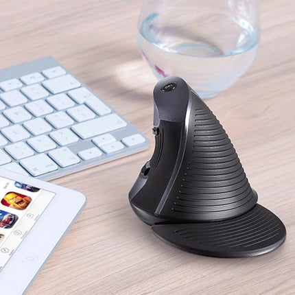 DELUX M618GX Wireless Ergonomic Vertical Mouse for Comfortable Navigation on desk next to keyboard and tablet, angled view showing handshake grip