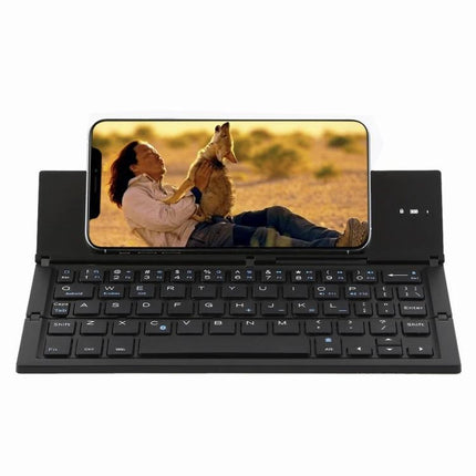 GK608 Ultra-Thin Foldable Bluetooth Keyboard with Built-in Holder showing smartphone in built-in stand for portable typing and travel use