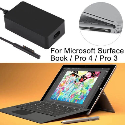 AC Power Adapter for Microsoft Surface Laptops and Tablets compact black charger with magnetic connector next to Surface tablet and stylus