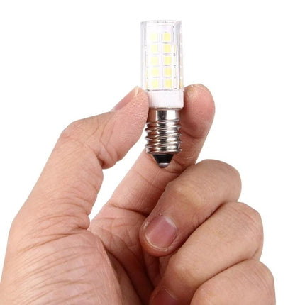Versatile LED Bulb for Everyday Home and Party Use held between fingers, compact E12 LED corn bulb for kitchen and backyard lighting