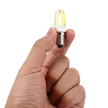 Hand holding small LED Bulb for Illuminating Home Halls and Living Areas showcasing compact energy-efficient design for halls and living areas