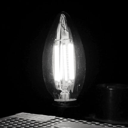Apiciform Retro LED Bulb for Everyday Home Lighting glowing filament-style LED in a bedside lamp providing even 360-degree light