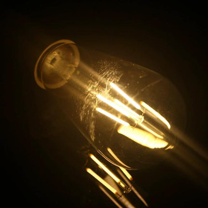 Retro LED Filament Bulb for Everyday Home Lighting Ambience glowing vintage filament in warm ambient living room light