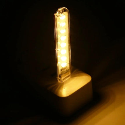 USB LED Book Light for Evening Reading and Travel showing warm LED strip plugged into a USB power source and illuminating pages