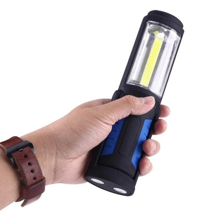 USB Charging Emergency Work Light With Magnetic Base held in hand showing COB LED, ergonomic grip, USB charging and magnetic base for hands-free use