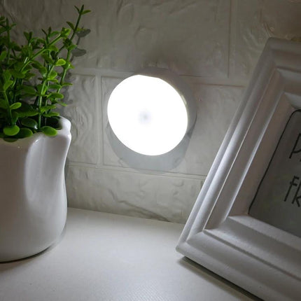 Compact USB Rechargeable Night Light for Home and Travel mounted on wall casting soft white light for reading and bedside use