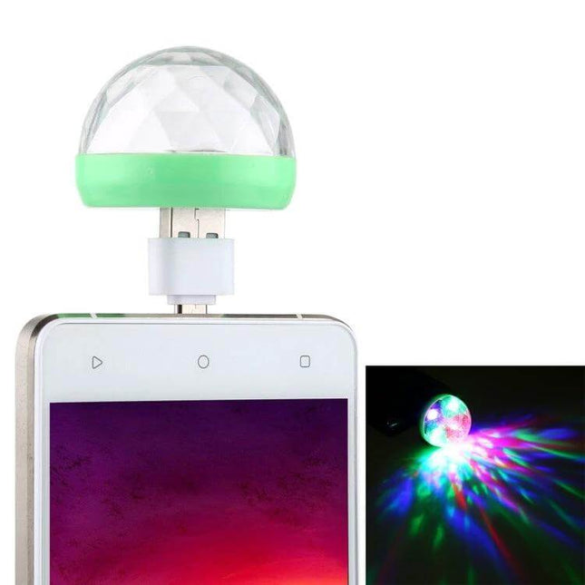 Rgb USB LED Crystal Ball Stage Light For Parties And Clubs plugged into phone showing green base and multicolor music synced projection