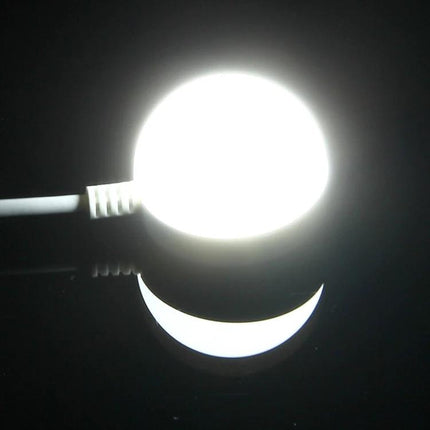 Compact USB Light for Travel and Daily Illumination Needs - bright round USB lamp with magnetic base reflected on dark surface