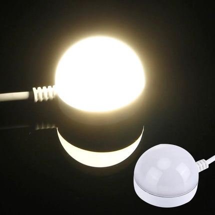 Compact USB Light for Travel and Daily Illumination Needs - glowing magnetic USB puck lamp plugged into power bank for soft bedside or travel lighting
