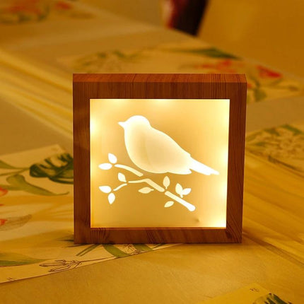 A Creative Night Light for Home Decoration and Bedtime with bird silhouette projection and warm wooden frame for relaxing bedside ambiance