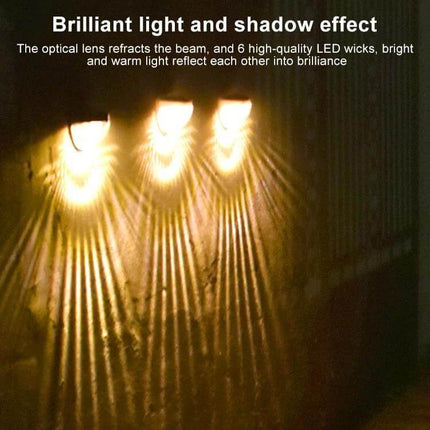Water Drop Fence Light 6 LED Outdoor Solar Garden Path glowing warm light on fence creating brilliant light and shadow effect