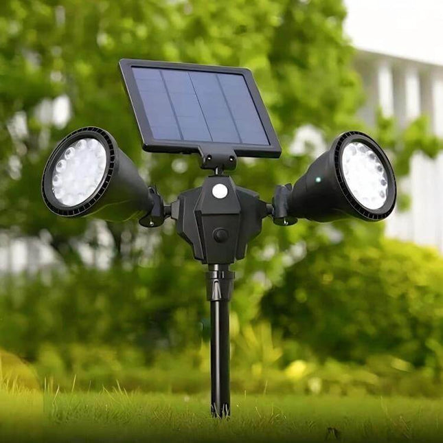 Robot Solar LED Spotlight Double-Headed With Motion Sensor mounted in garden with dual LED heads and solar panel