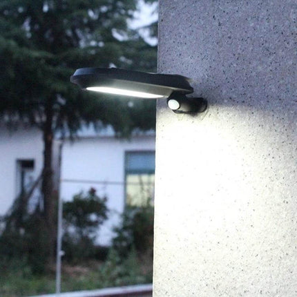Solar Garden Lamp With Motion Sensor Waterproof Outdoor mounted on wall illuminating pathway at dusk, motion-activated waterproof LED security light