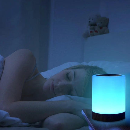Atmospheric Wood Grain Night Light for Cozy Home Evenings on bedside table casting soft blue glow next to sleeping person