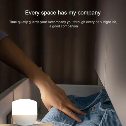 USB Mini Night Light for Daily Home and Travel Use showing gentle white light on bedside table being used to read or find items during travel