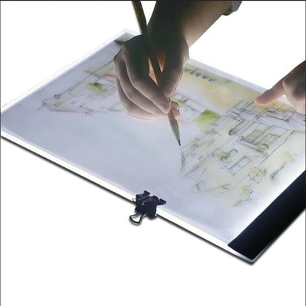 A4 Portable USB LED Tracing Light Box for Art and Design showing hands tracing a sketch on slim illuminated A4 panel