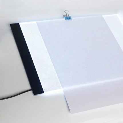 A4 Portable USB LED Tracing Light Box for Art and Design showing slim illuminated board with paper clipped for precise tracing