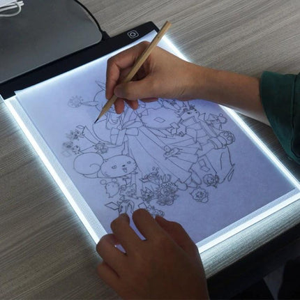 A4 Portable LED Tracing Light Box for Drawing and Sketching being used to trace a detailed sketch with pencil