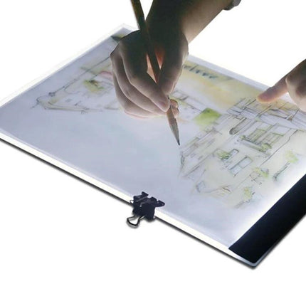 A4 Portable LED Tracing Light Box for Drawing and Sketching showing hands tracing an architectural sketch with even adjustable illumination