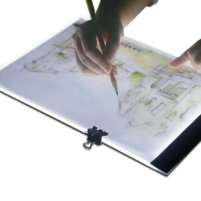 A4 Portable LED Tracing Light Box for Drawing and Sketching showing hands tracing an architectural sketch with even adjustable illumination