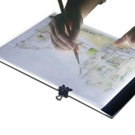 A4 Portable LED Tracing Light Box for Drawing and Sketching showing hands tracing architectural sketch with adjustable slim illuminated board