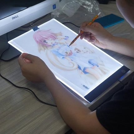 A4 Portable LED Tracing Light Box for Drawing and Sketching being used to trace anime artwork with even adjustable illumination