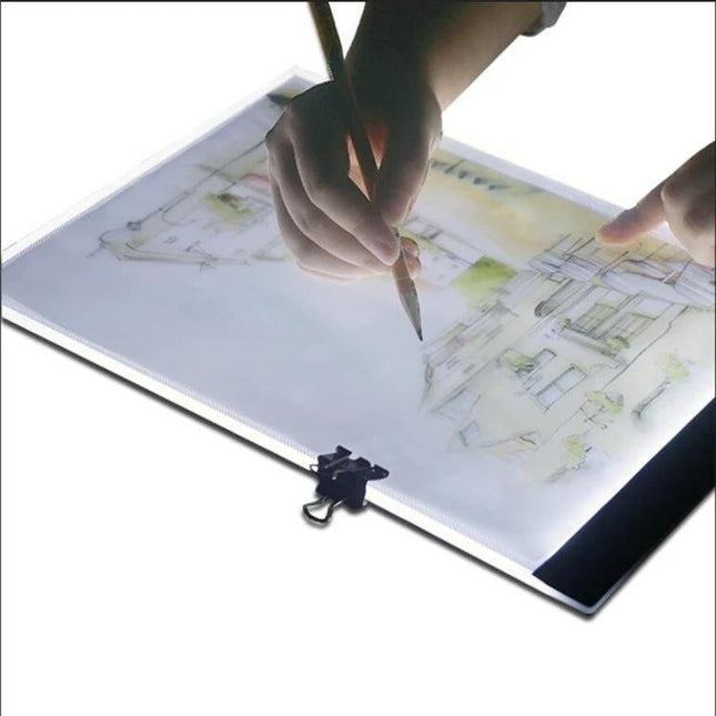 A4 Tracing Light Box for Drawing, Sketching, and Design Work - artist tracing architectural sketch on illuminated A4 light pad for precise drafting