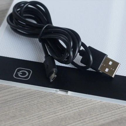 A4 Tracing Light Box for Drawing, Sketching, and Design Work showing USB power cable and touch power button on edge