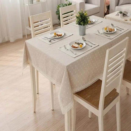 Lace Tablecloth For Dining And Events In Linen Blend draped on dining table with place settings and lace trim