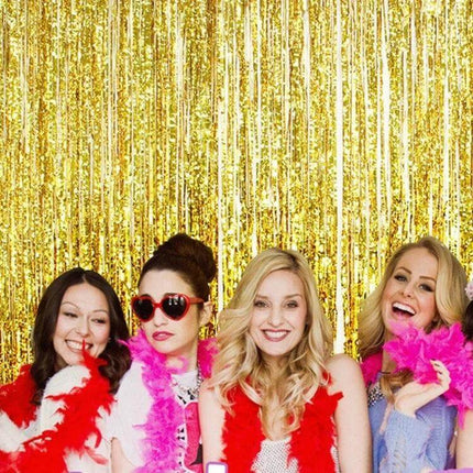 Laser Rain Tinsel Foil Curtain 1m X 3m Wall Decor For Celebrations gold foil backdrop with four women wearing colorful feather boas posing in front