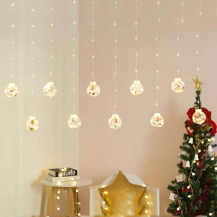 Led Copper Wire Curtain Lights With Wishing Ball For Christmas Decor hung as warm curtain lights above a festive living room scene