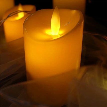 LED Flameless Cylindrical Candle With Remote For Home Decor showing warm yellow LED glow on a white cylindrical candle for tabletop ambiance