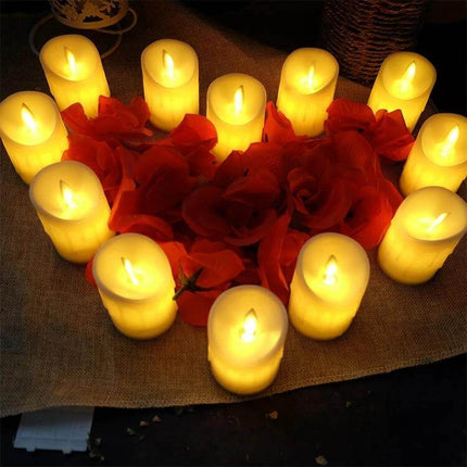 LED Flameless Cylindrical Candle With Remote For Home Decor arranged in warm yellow glow around red rose petals on a table centerpiece