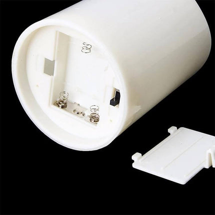 LED Flameless Cylindrical Candle With Remote For Home Decor showing battery compartment and removable cover on white cylinder