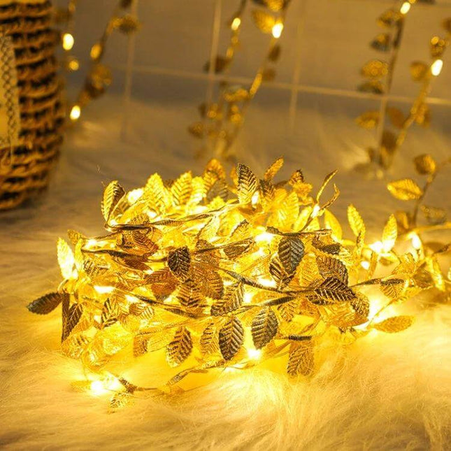 LED Golden Leaf Vine Light String, 2m For Holiday Decor glowing golden leaf vine lights draped on fur for Christmas and wedding decor