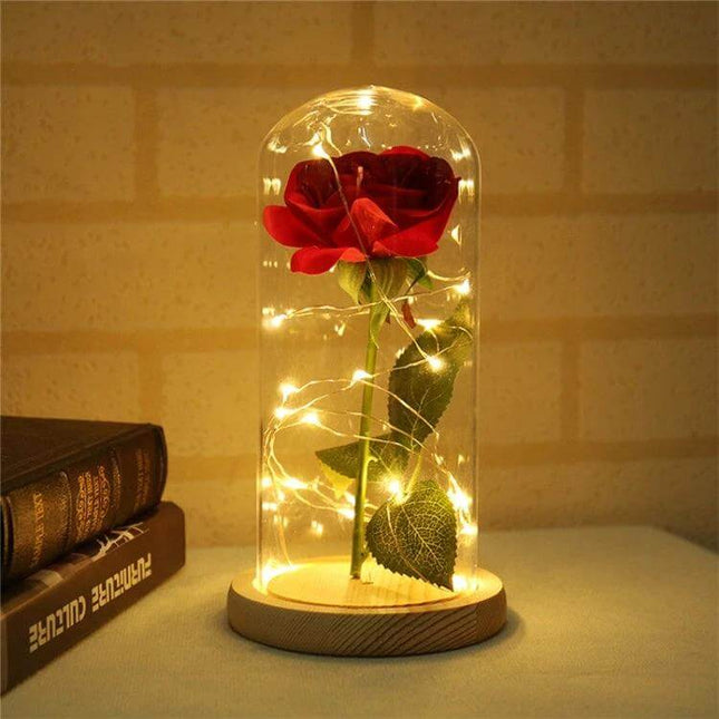 LED Light Rose With Glass Dome For Romantic Home Decor on wooden base with warm LED fairy lights and red rose