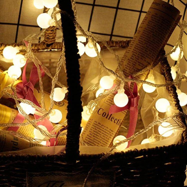 LED Waterproof Ball Light String For Indoor And Outdoor Use, 20 LEDs draped inside a wicker basket as warm decorative patio and event lighting