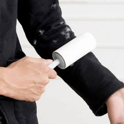 Long-Handle Sticky Roller for Clothing Pilling Removal, 22 cm being used on a black sweater sleeve to lift lint and pills