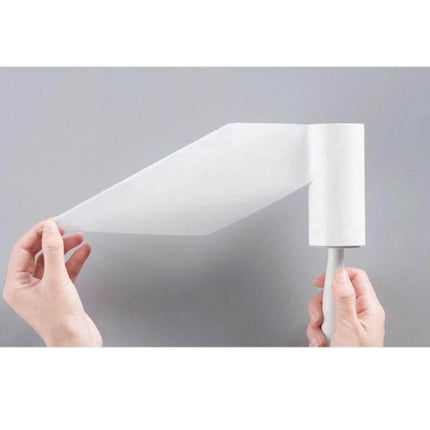 Long-Handle Sticky Roller for Clothing Pilling Removal, 22 cm shown with tear-off adhesive sheet being peeled from roller