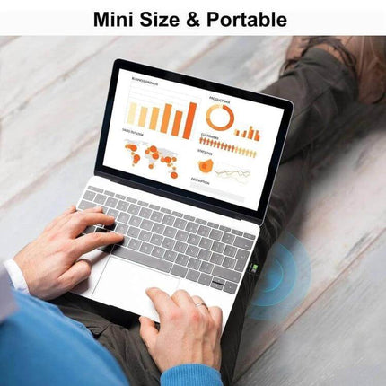 Dual-Band Wireless USB Adapter for Home Network Connectivity shown as a mini portable USB adapter boosting laptop WiFi in a home office